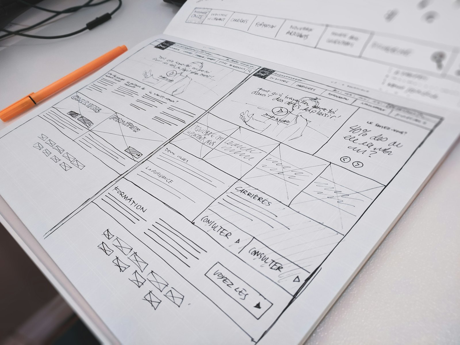 Website wireframe sketches in a notebook